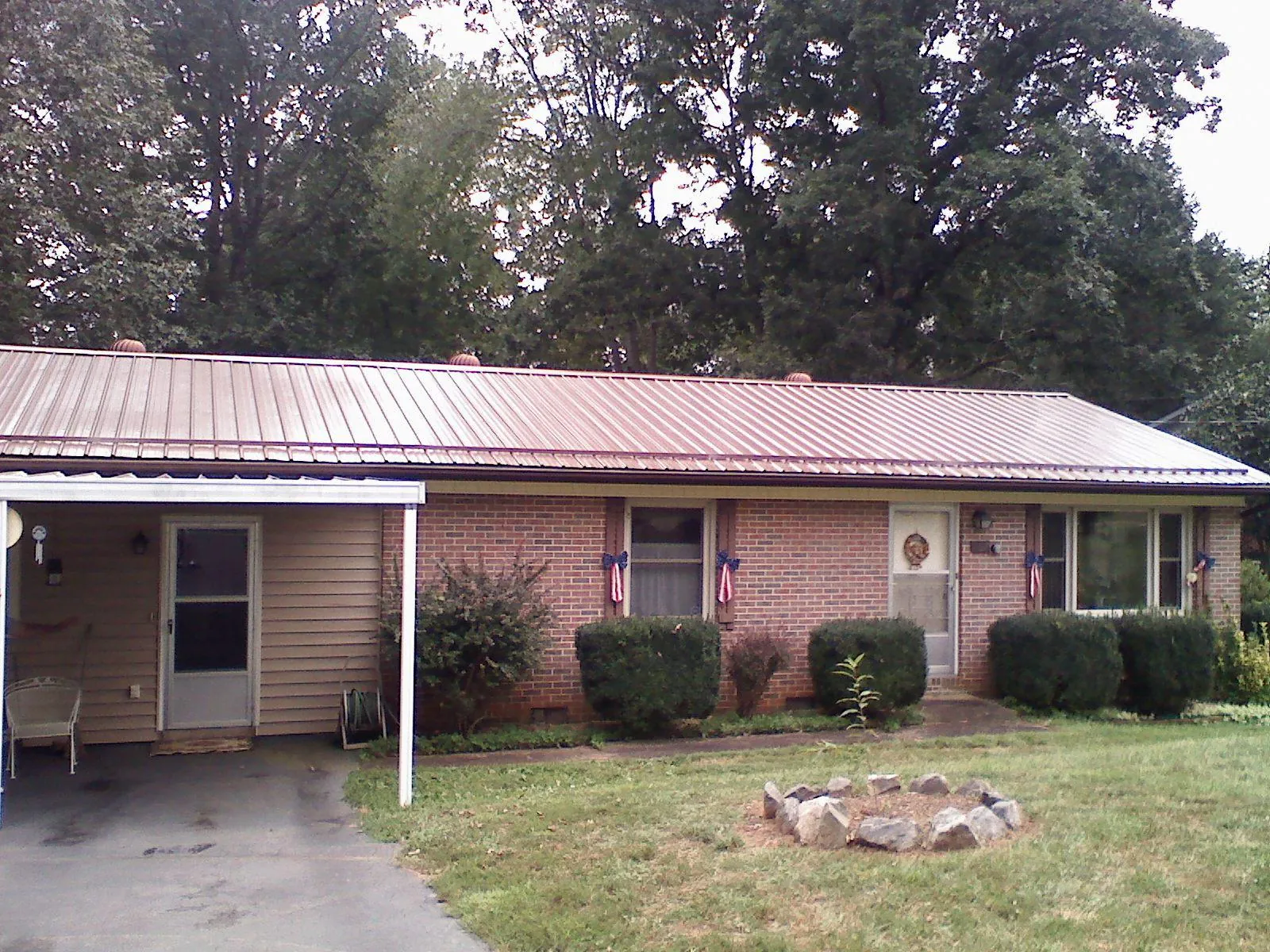 Bronze metal roof and carport on a brick ranch home — Roof Repair work by our crew in Wrightwood